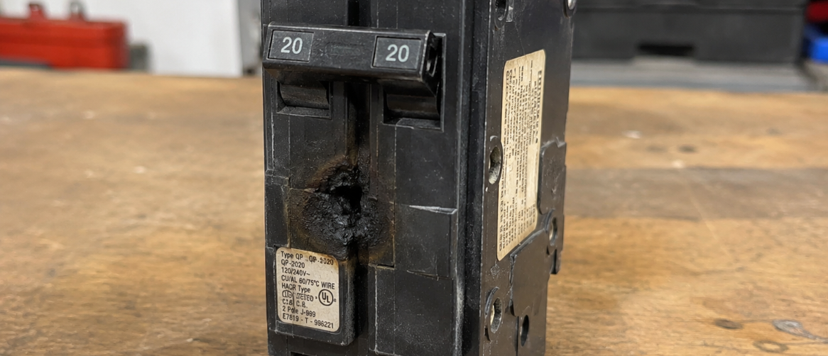 Burned electrical panel breaker sitting on a table
